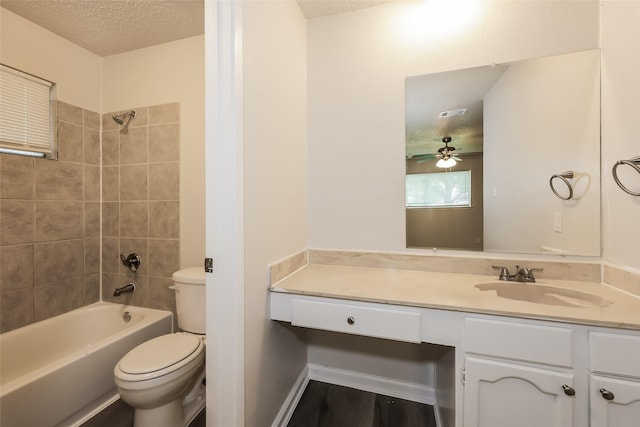 1421 Monica Ct, Mesquite, TX 75149 - full bathroom featuring toilet, vanity, a textured ceiling, washtub / shower combination, and ceiling fan