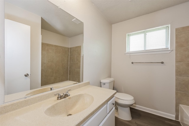 1421 Monica Ct, Mesquite, TX 75149 - full bathroom featuring toilet, vanity, wood finished floors, and baseboards