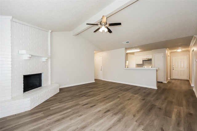 1421 Monica Ct, Mesquite, TX 75149 - unfurnished living room featuring ceiling fan, dark wood-type flooring, baseboards, a brick fireplace, and a textured ceiling