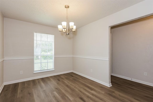 1421 Monica Ct, Mesquite, TX 75149 - unfurnished room with a chandelier, wood finished floors, and baseboards