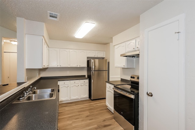 1421 Monica Ct, Mesquite, TX 75149 - kitchen with stainless steel appliances, a sink, under cabinet range hood, light wood-style floors, and white cabinets