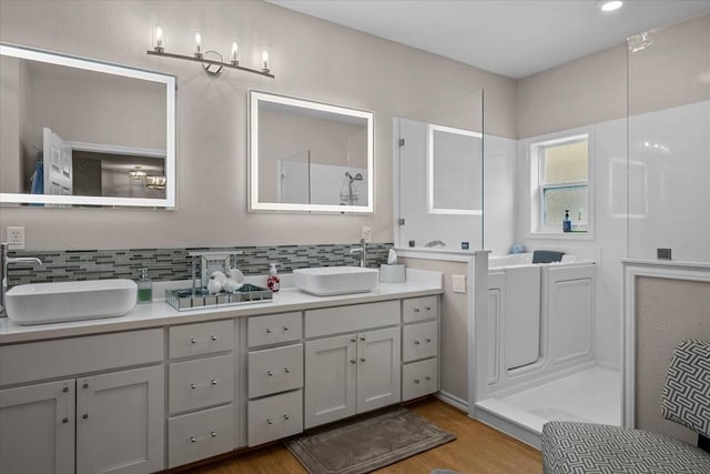 114 Deer Run, Moody, TX 76557 - full bath featuring wood finished floors, double vanity, and backsplash