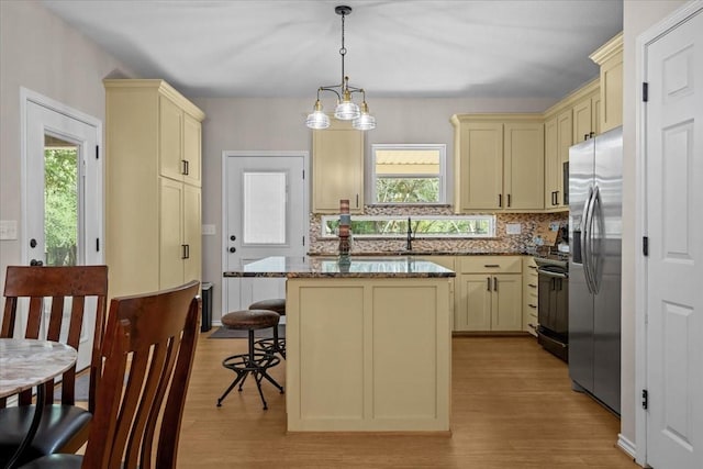114 Deer Run, Moody, TX 76557 - kitchen featuring cream cabinetry, black stove, stainless steel fridge with ice dispenser, and plenty of natural light