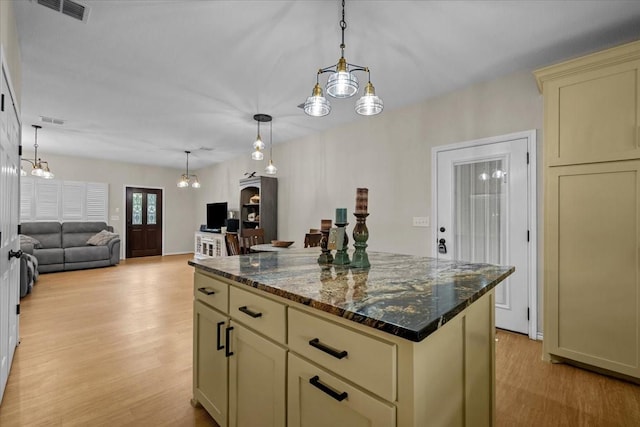 114 Deer Run, Moody, TX 76557 - kitchen featuring cream cabinets, light wood-style floors, a kitchen island, open floor plan, and hanging light fixtures