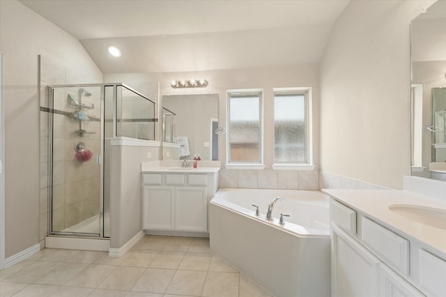 2205 Perrymead Dr, Forney, TX 75126 - bathroom with vaulted ceiling, a shower stall, a garden tub, two vanities, and tile patterned flooring