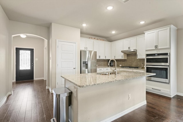 2205 Perrymead Dr, Forney, TX 75126 - kitchen with stainless steel appliances, arched walkways, tasteful backsplash, white cabinets, and recessed lighting