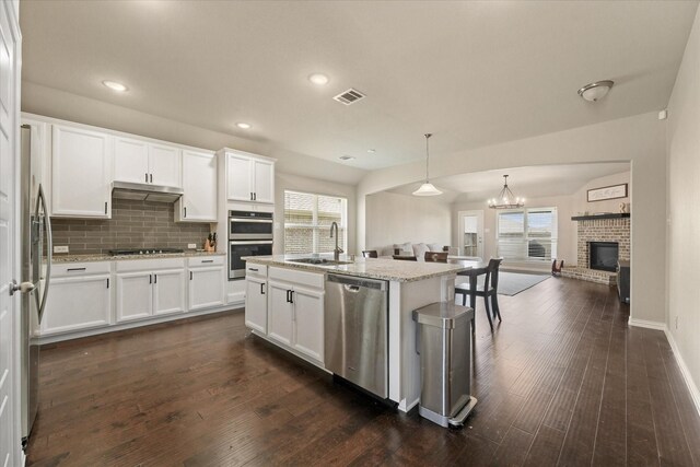 2205 Perrymead Dr, Forney, TX 75126 - kitchen with stainless steel appliances, open floor plan, dark wood-style floors, tasteful backsplash, and white cabinetry