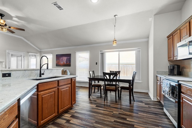 14137 Playa Trl, Fort Worth, TX 76052 - kitchen featuring stainless steel appliances, a sink, vaulted ceiling, brown cabinets, and a ceiling fan