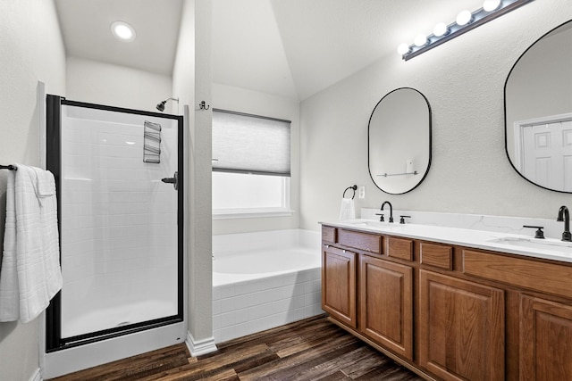14137 Playa Trl, Fort Worth, TX 76052 - full bathroom featuring a shower stall, a garden tub, double vanity, wood finished floors, and lofted ceiling