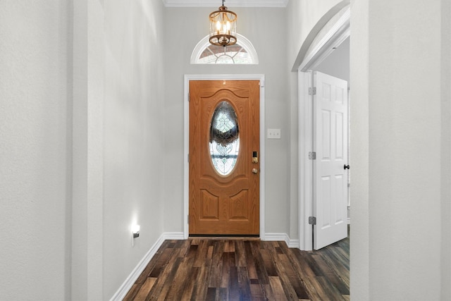 14137 Playa Trl, Fort Worth, TX 76052 - foyer featuring a chandelier, dark wood-type flooring, baseboards, and crown molding