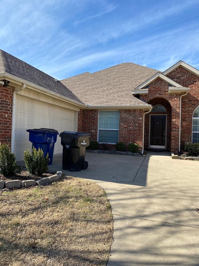 12811 Greenhaven Dr, Frisco, TX 75035 - view of front facade with driveway, a garage, brick siding, and a shingled roof