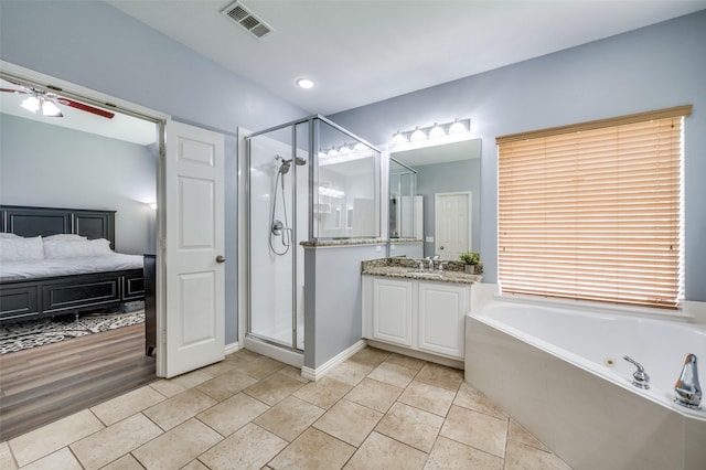 11543 Las Polamas Dr, Frisco, TX 75033 - ensuite bathroom with vanity, a shower stall, a whirlpool tub, and a ceiling fan