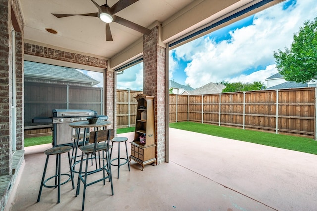 11543 Las Polamas Dr, Frisco, TX 75033 - fenced backyard featuring a patio area, a ceiling fan, and grilling area