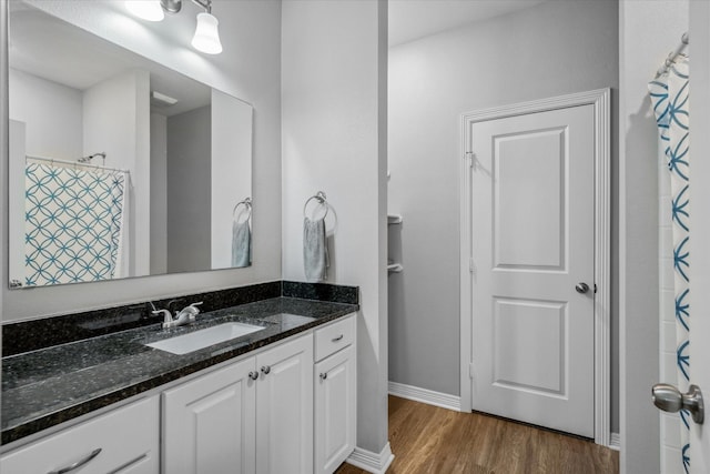 2939 Meadow Brook Trl, Tyler, TX 75701 - bathroom featuring wood finished floors, vanity, baseboards, and a shower with curtain
