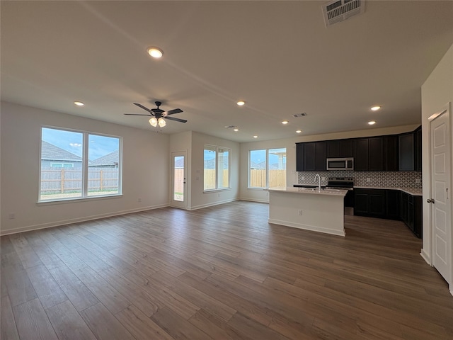 4049 Rimfire Rd, Waco, TX 76705 - unfurnished living room featuring a sink, wood finished floors, a ceiling fan, recessed lighting, and baseboards