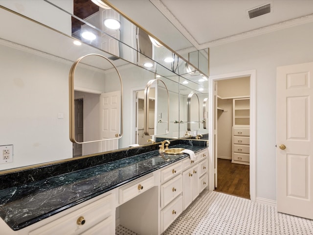 7 Duncannon Ct, Dallas, TX 75225 - bathroom featuring ornamental molding, tile patterned floors, vanity, and a spacious closet