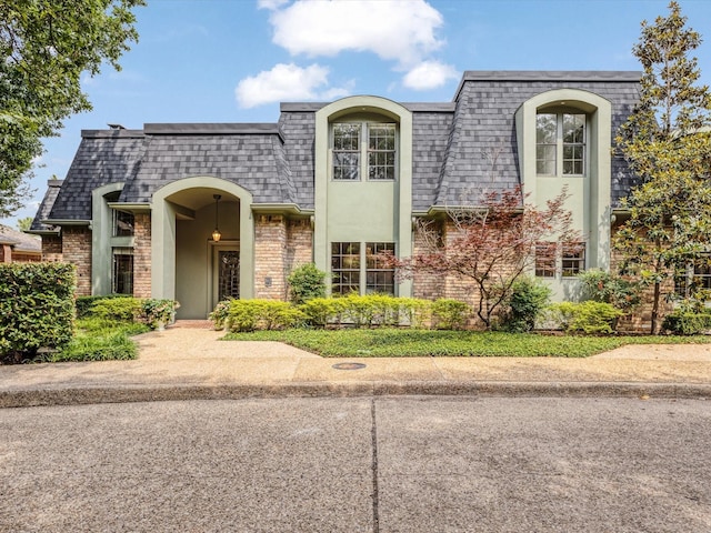 7 Duncannon Ct, Dallas, TX 75225 - view of front of property featuring mansard roof, roof with shingles, brick siding, and stucco siding