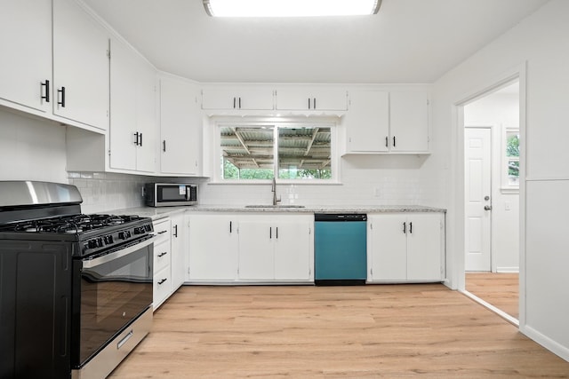 1942 Woodard St, Abilene, TX 79605 - kitchen with range with gas stovetop, dishwasher, a sink, stainless steel microwave, and light wood finished floors