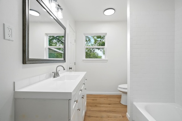 1942 Woodard St, Abilene, TX 79605 - full bath featuring vanity, toilet, wood finished floors, baseboards, and tub / shower combination