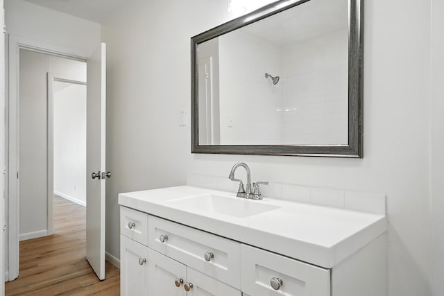 1942 Woodard St, Abilene, TX 79605 - full bathroom featuring vanity, wood finished floors, and baseboards