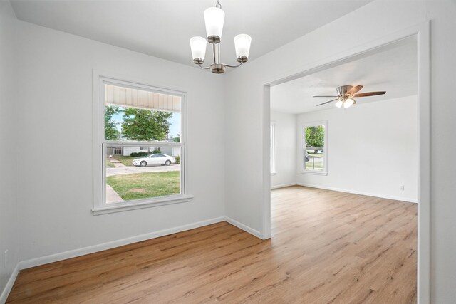 1942 Woodard St, Abilene, TX 79605 - empty room with light wood-style flooring, a chandelier, and baseboards
