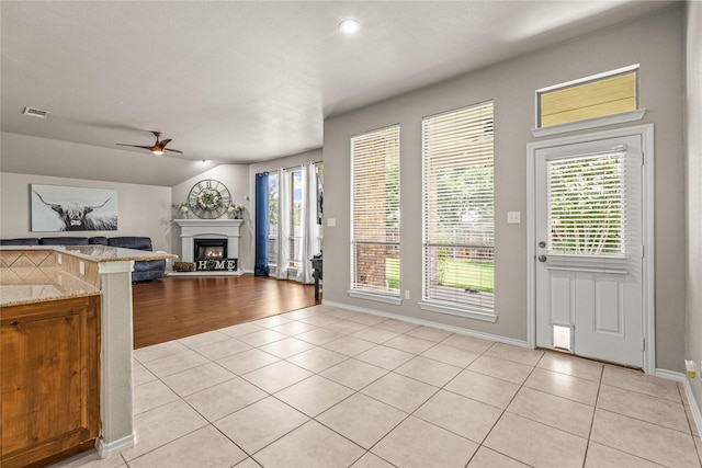 1917 Winter Hawk Dr, Fort Worth, TX 76177 - kitchen with light tile patterned floors, ceiling fan, a fireplace, baseboards, and recessed lighting