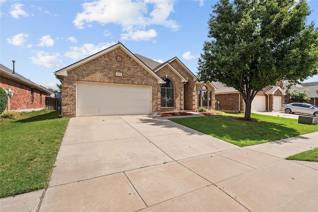 1917 Winter Hawk Dr, Fort Worth, TX 76177 - view of front of property featuring an attached garage, a front yard, driveway, and brick siding