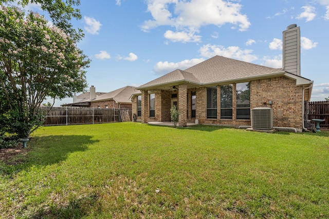 1917 Winter Hawk Dr, Fort Worth, TX 76177 - rear view of property featuring a ceiling fan, central AC, a chimney, brick siding, and a patio area