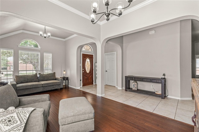 1917 Winter Hawk Dr, Fort Worth, TX 76177 - living room with a chandelier, arched walkways, wood finished floors, vaulted ceiling, and baseboards