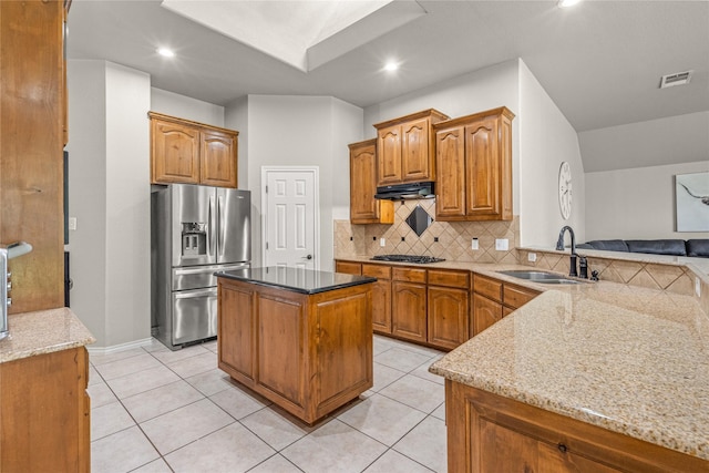 1917 Winter Hawk Dr, Fort Worth, TX 76177 - kitchen featuring stainless steel fridge, a sink, black gas stovetop, under cabinet range hood, and tasteful backsplash