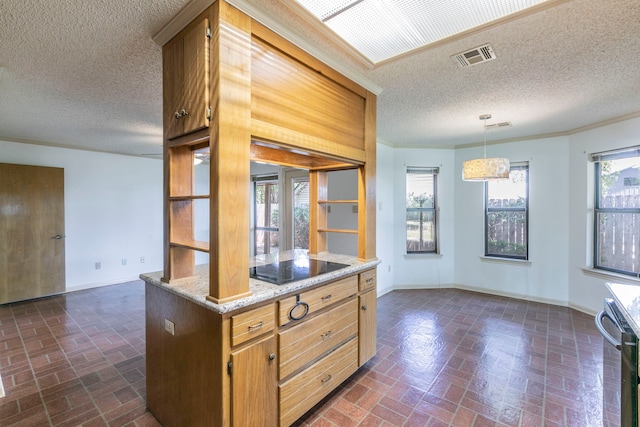 1604 Oak Hollow Dr, Woodway, TX 76712 - kitchen featuring brick patterned floors, baseboards, a textured ceiling, black electric stovetop, and hanging light fixtures