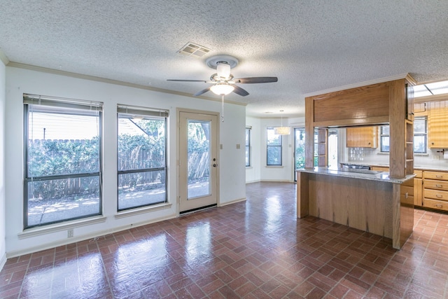 1604 Oak Hollow Dr, Woodway, TX 76712 - kitchen featuring brick patterned flooring, ceiling fan, baseboards, a textured ceiling, and light countertops