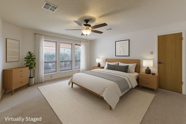 1604 Oak Hollow Dr, Woodway, TX 76712 - bedroom with light carpet, a ceiling fan, and a textured ceiling