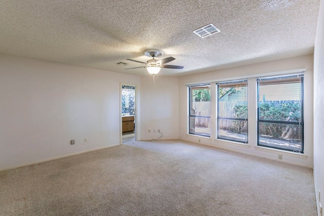 1604 Oak Hollow Dr, Woodway, TX 76712 - empty room featuring light colored carpet, a ceiling fan, a textured ceiling, and baseboards