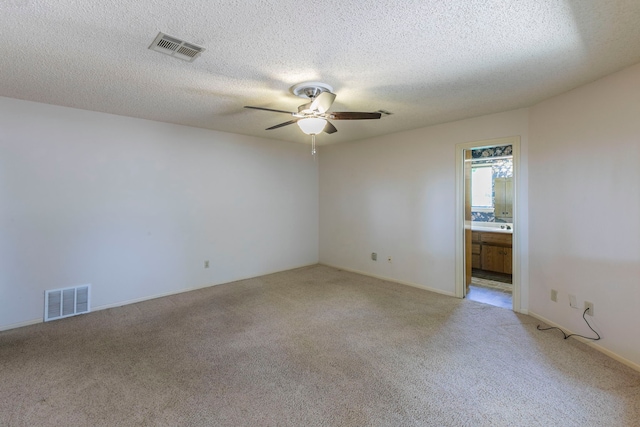 1604 Oak Hollow Dr, Woodway, TX 76712 - empty room with light colored carpet, ceiling fan, and a textured ceiling