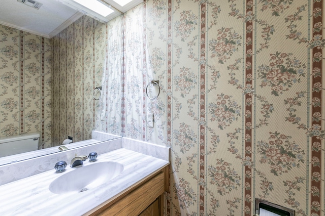 1604 Oak Hollow Dr, Woodway, TX 76712 - bathroom with ornamental molding, vanity, and toilet