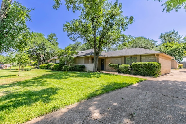 1604 Oak Hollow Dr, Woodway, TX 76712 - view of front of property with brick siding, a front lawn, concrete driveway, and a shingled roof