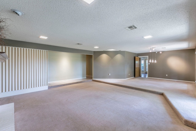 1604 Oak Hollow Dr, Woodway, TX 76712 - empty room featuring light colored carpet, baseboards, and a textured ceiling