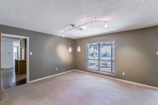 1604 Oak Hollow Dr, Woodway, TX 76712 - carpeted empty room with track lighting, baseboards, and a textured ceiling