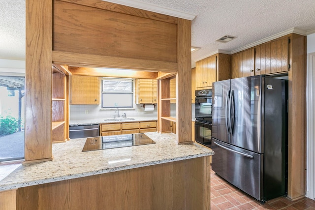1604 Oak Hollow Dr, Woodway, TX 76712 - kitchen with black appliances, a textured ceiling, a sink, ornamental molding, and a peninsula