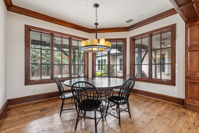 44 Armstrong Dr, Frisco, TX 75034 - dining room with baseboards, wood finished floors, crown molding, and a chandelier