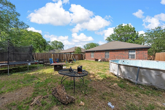 1012 Hatton St, Waco, TX 76704 - view of yard featuring a trampoline and a fire pit