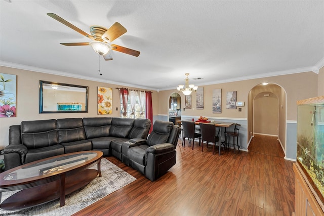 1012 Hatton St, Waco, TX 76704 - living room with arched walkways, ornamental molding, wood finished floors, a chandelier, and ceiling fan