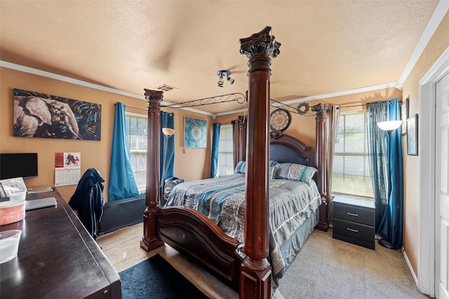 1012 Hatton St, Waco, TX 76704 - bedroom featuring ornamental molding, a textured ceiling, light colored carpet, and decorative columns