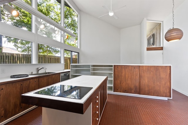 1703 E Barbara St, Tyler, TX 75701 - kitchen featuring a sink, black electric cooktop, ceiling fan, a kitchen island, and light countertops