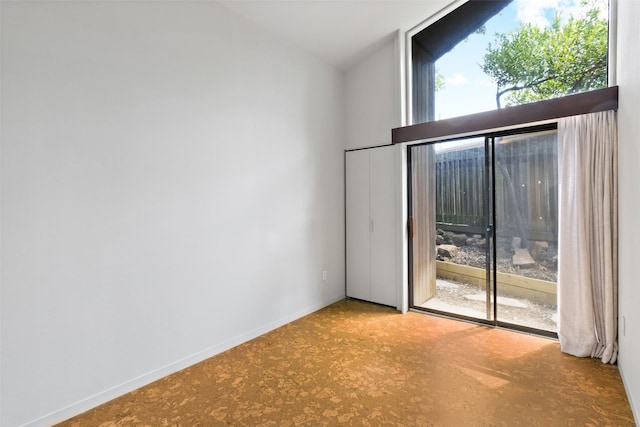 1703 E Barbara St, Tyler, TX 75701 - empty room featuring vaulted ceiling and baseboards