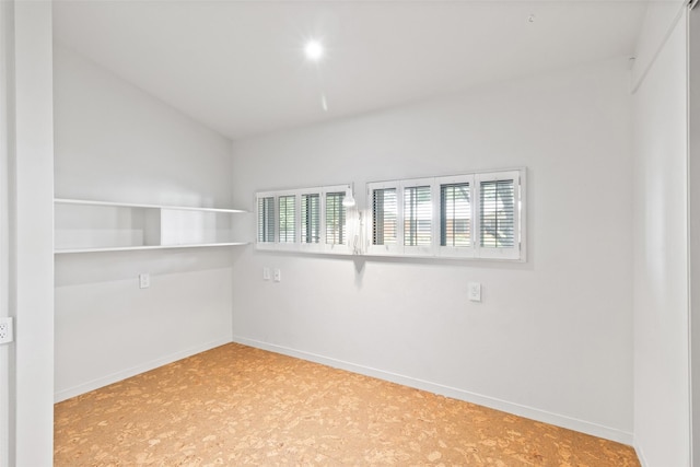 1703 E Barbara St, Tyler, TX 75701 - unfurnished room with plenty of natural light, lofted ceiling, and baseboards