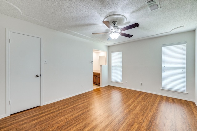 2505 Blue Quail Dr, Arlington, TX 76017 - empty room featuring wood finished floors, a textured ceiling, a ceiling fan, and baseboards