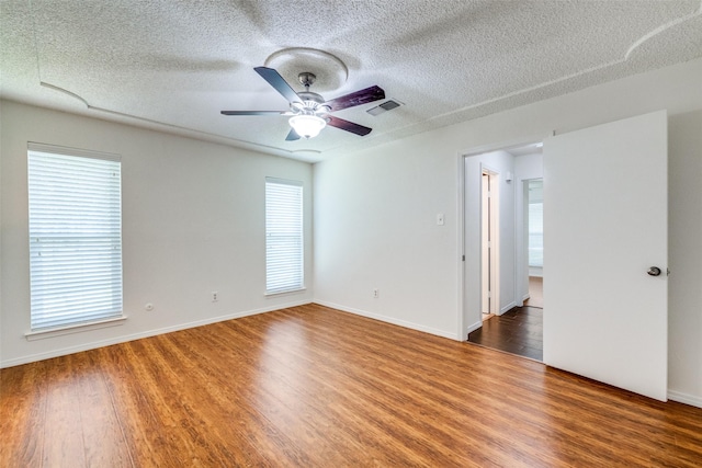 2505 Blue Quail Dr, Arlington, TX 76017 - empty room featuring wood finished floors, a textured ceiling, a ceiling fan, and baseboards
