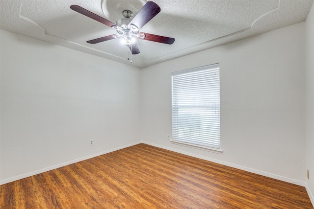 2505 Blue Quail Dr, Arlington, TX 76017 - unfurnished room with wood finished floors, baseboards, ceiling fan, and a textured ceiling